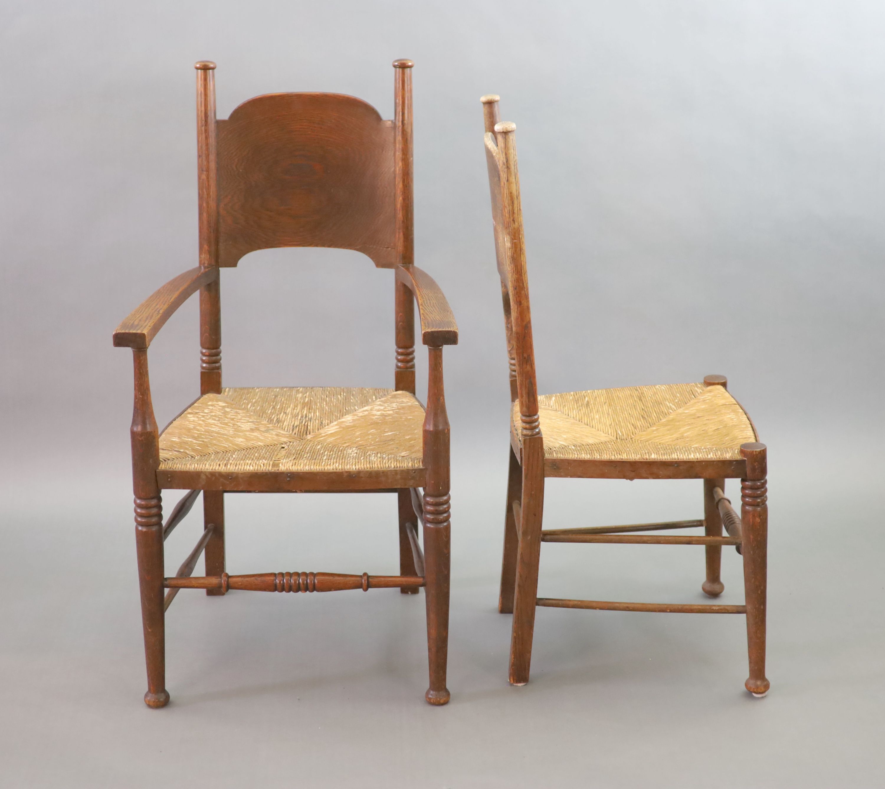 A set of six oak chairs, including a pair of carvers, in the Glasgow School manner by William Birch, High Wycombe, carvers W.58cm D.54cm H.109cm